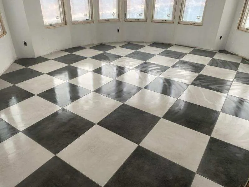 Polished black and white checkerboard tile floor in a bright curved room